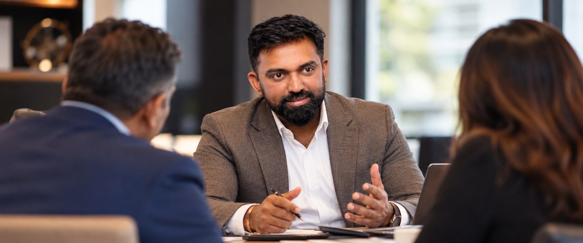 The Wealth Architecture Review Abhi Paul in a consultation with a couple at a table